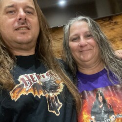 James & Theresa — Couples who rep Hellion together stay metal forever. James and Theresa posing together wearing Hellion merchandise.